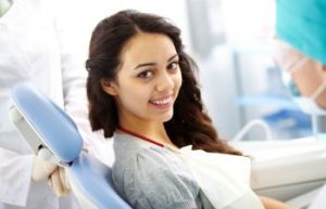 Smiling Woman Sitting in a Dentist Chair