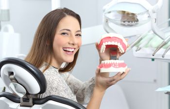 the patient holds a model of the jaw in his hands