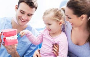 dentist teach little girl how to clean your teeth