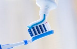 Toothpaste Being Applied on Toothbrush