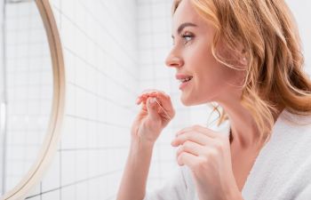 Woman flossing her teeth.