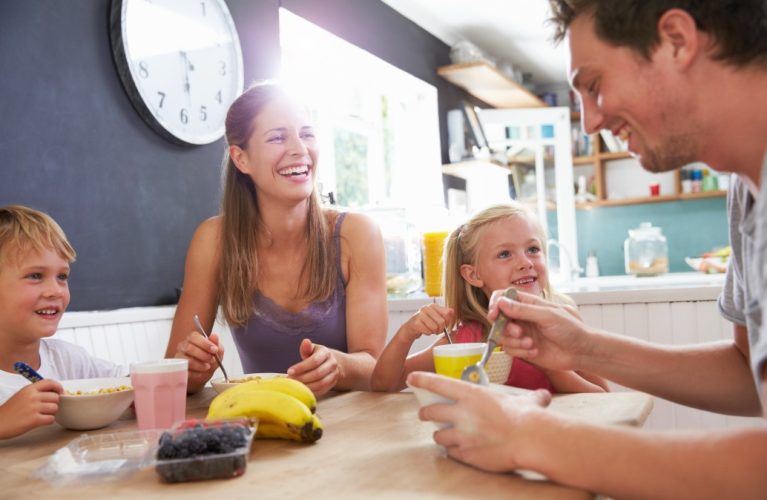 Family Eating Breakfast At Kitchen Table